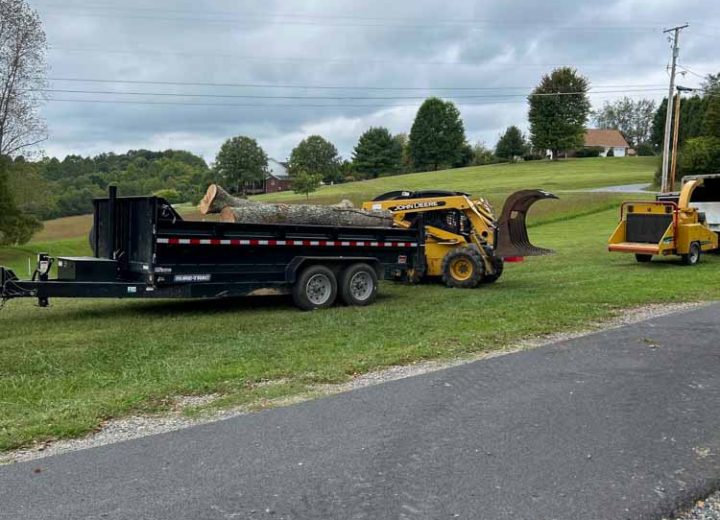 Tree maintenance equipment and debris placed along a rural roadside, depicting the ongoing work of tree removal and land clearing in a rural setting.